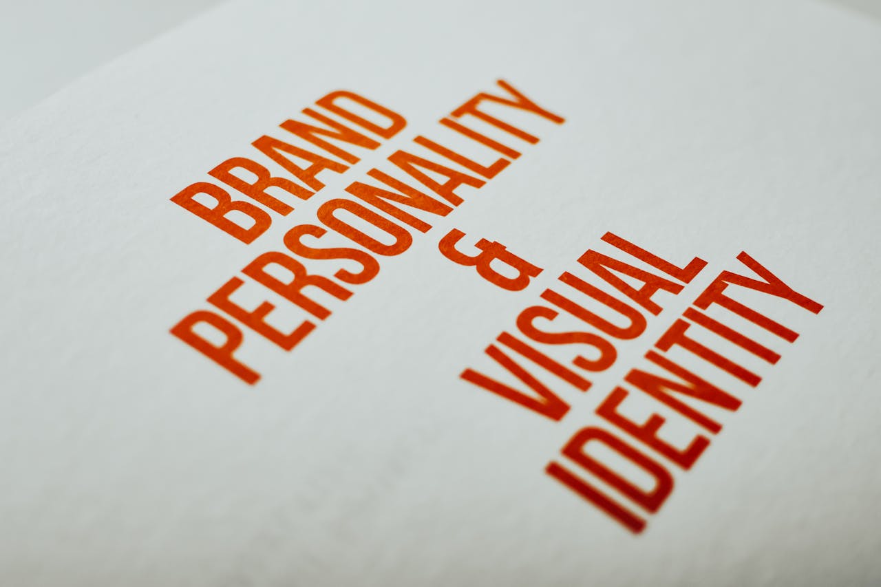 expertise-01 Close-up of 'Brand Personality & Visual Identity' text in red on white paper.